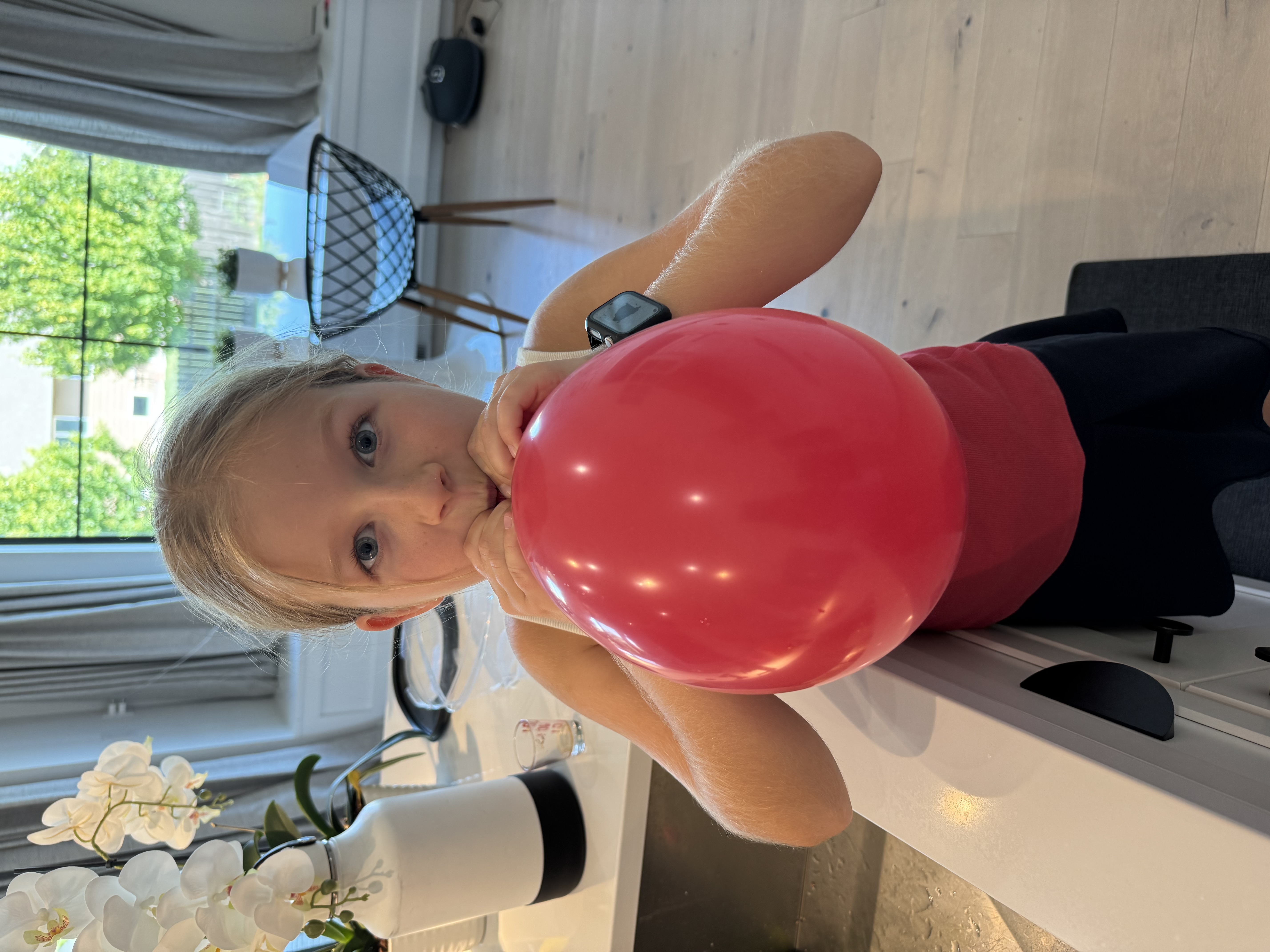 Blowing up a red balloon